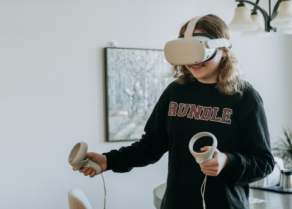 A young school girl using a virtual reality headset.