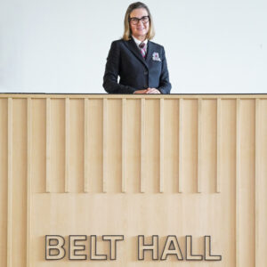 Mrs. Allison Belt stands near the sign bearing her name in the new Belt Hall