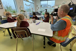 Kindergarten students play in their classroom as a CTV cameraman films