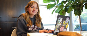 A Rundle Studio student sits at her laptop at the dining room at home.