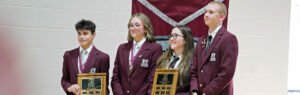 A group of four Rundle Academy students pose with plaques during the Academy Awards Ceremony.