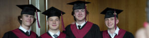 Rundle Academy | Grade 12 students pose together in their cap and gown at graduation | private school calgary