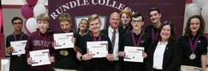 Rundle Studio students proudly posing with their academic achievement awards.