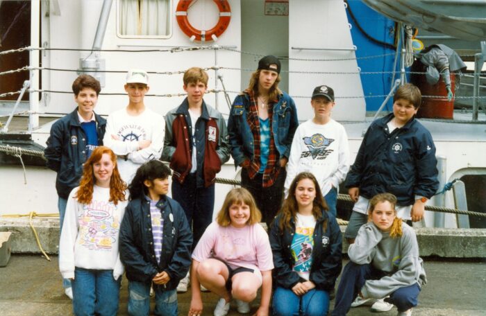 Rundle College Students together in front of a boat. 