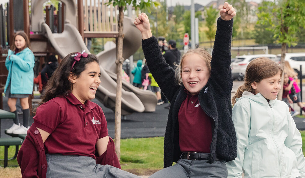 Rundle students cheer and smile while playing outside